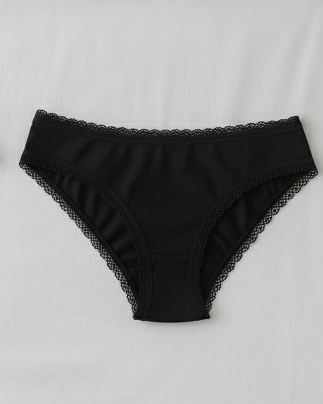 Women’s underwear with thick supportive fabric and delicate lace edges, displayed flat in soft neutral tones for everyday comfort and feminine style.