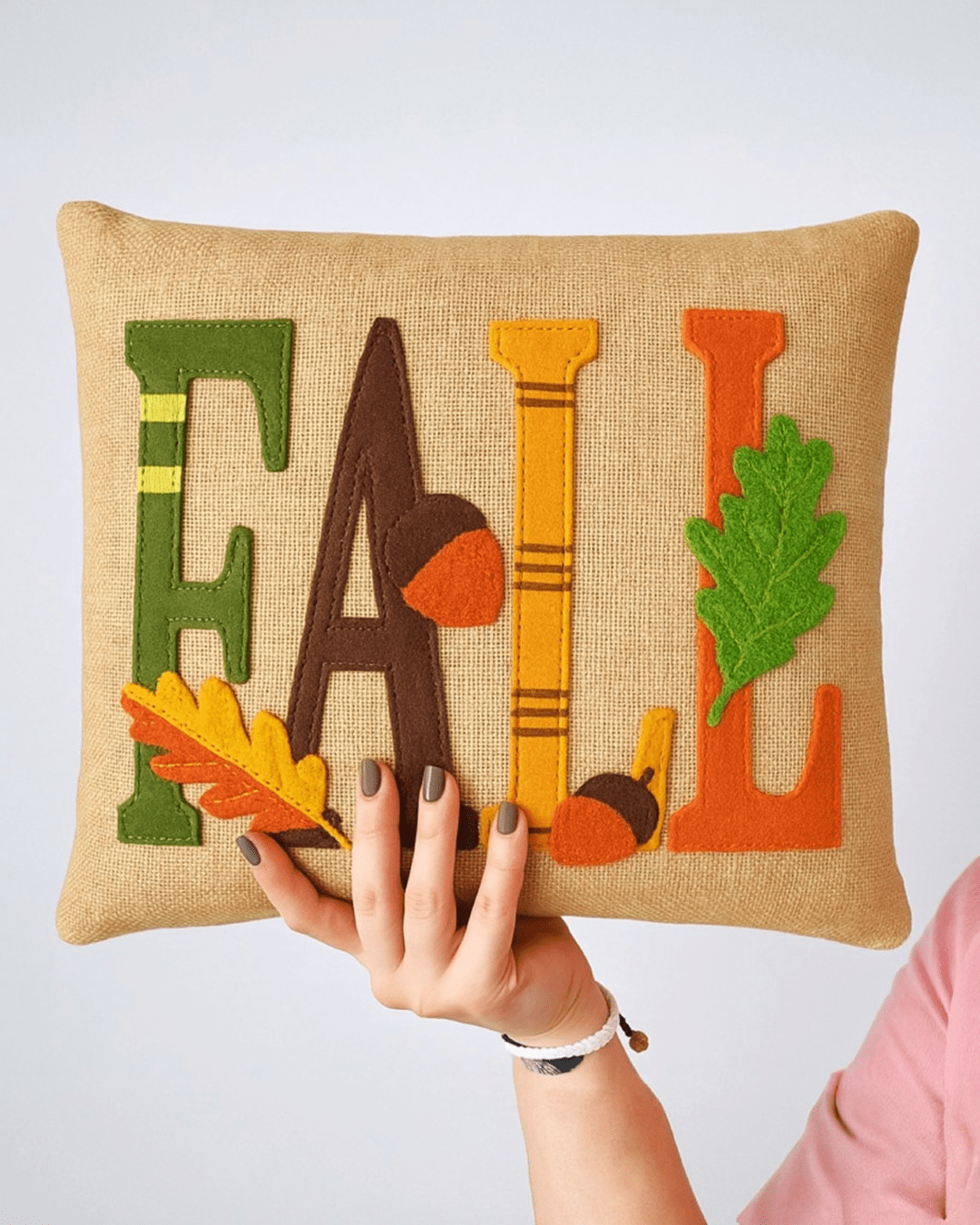 Punch needle decorative cushion with textured tufted design displayed on a modern sofa, neutral cozy home interior styling.