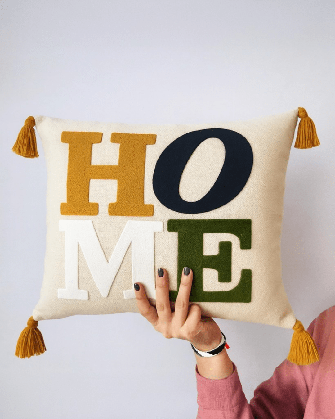 Punch needle decorative cushion with textured tufted design displayed on a modern sofa, neutral cozy home interior styling.