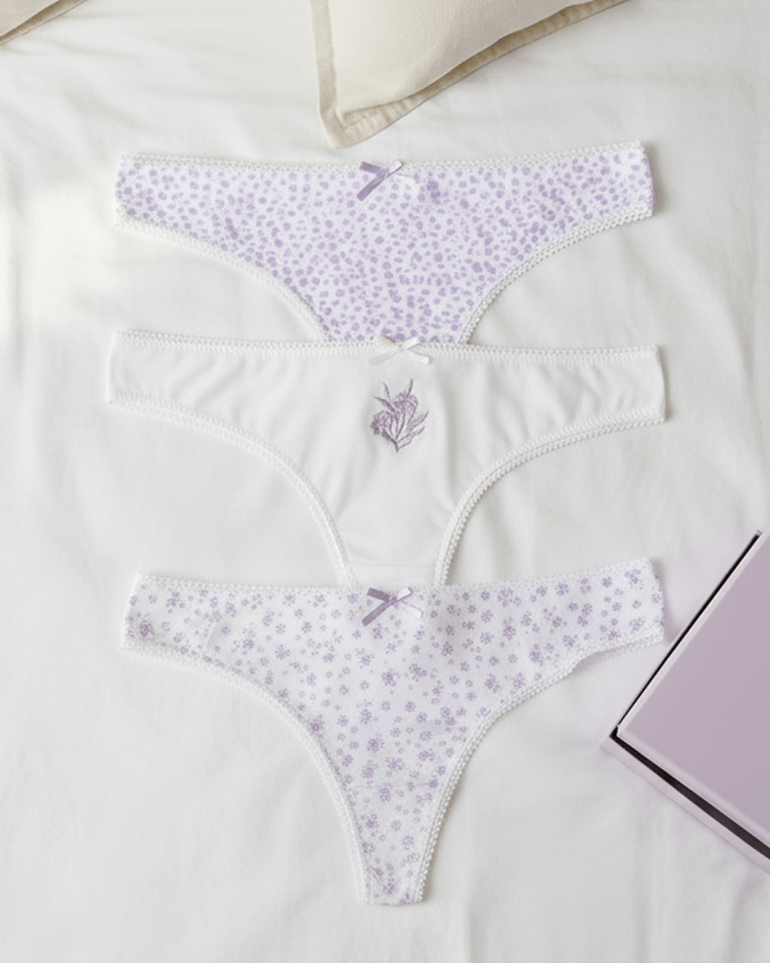 Set of KOZA women’s thongs in lavender and white floral prints, 100% Turkish cotton soft breathable fabric, thong cut underwear displayed flat.