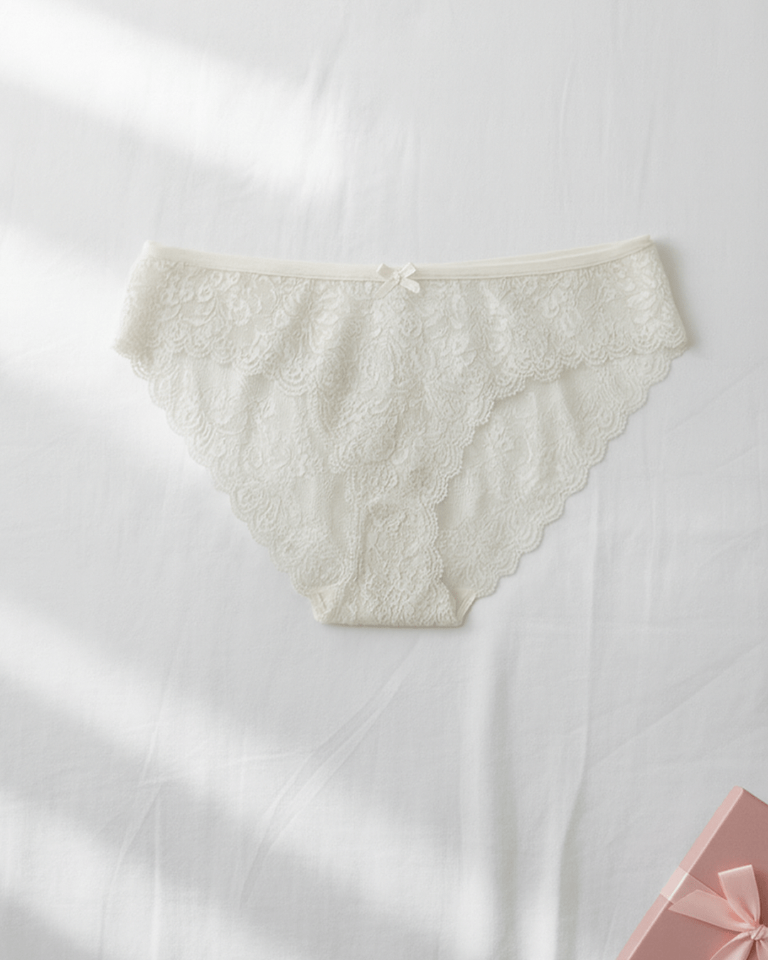 White lace women’s underwear in size S/M displayed flat, delicate floral lace design with smooth invisible finish.