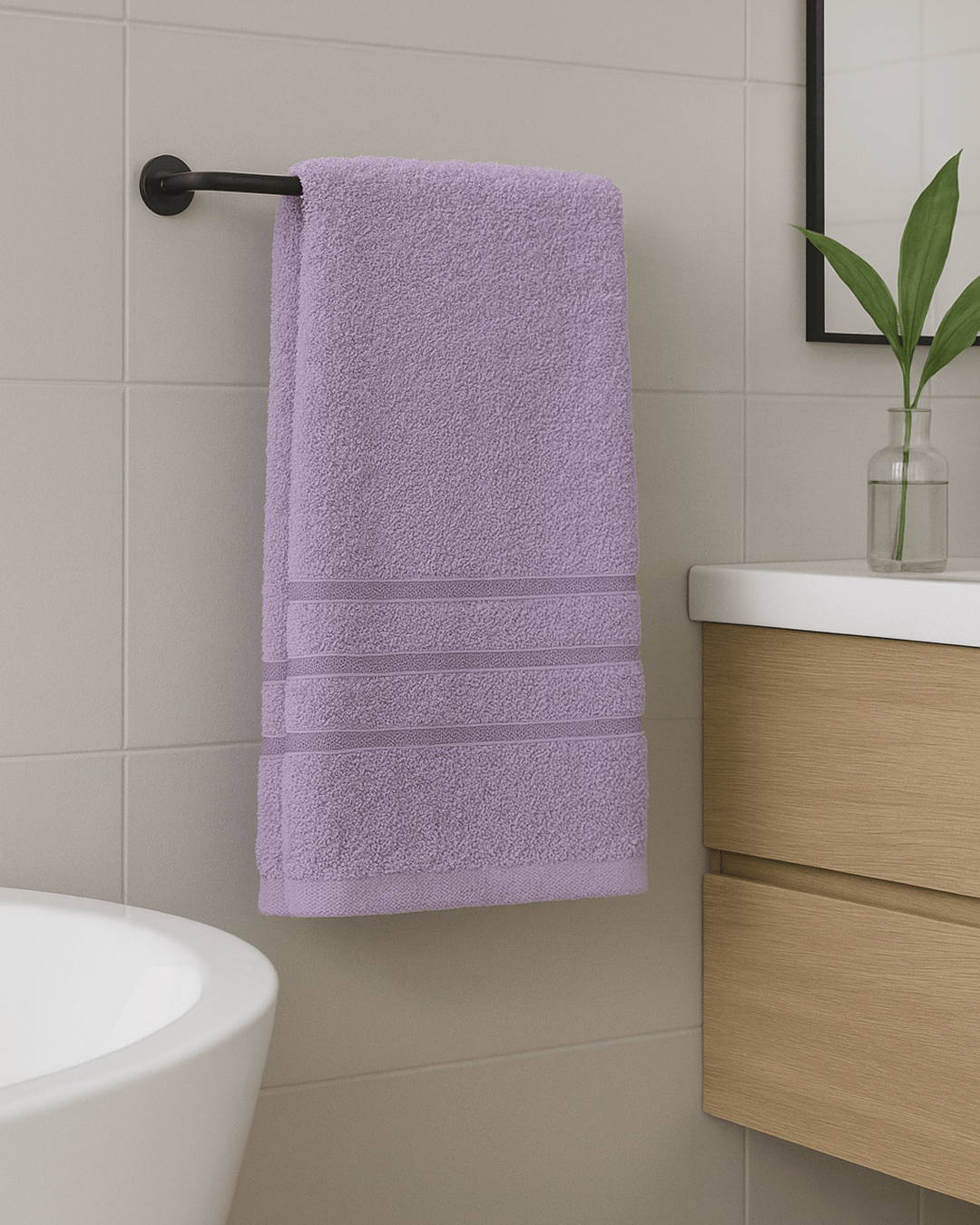 Folded 50x90 cm hand and face towels made from 100% Turkish cotton, soft and absorbent bathroom textiles in neutral tones.