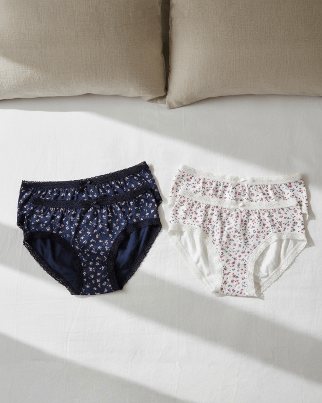 Women’s underwear with thick supportive fabric and delicate lace edges, displayed flat in soft neutral tones for everyday comfort and feminine style.